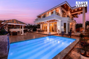 StayVista's Ivory Grandeur - Valley-View Villa with Outdoor Pool, Lawn featuring a Gazebo & Machan